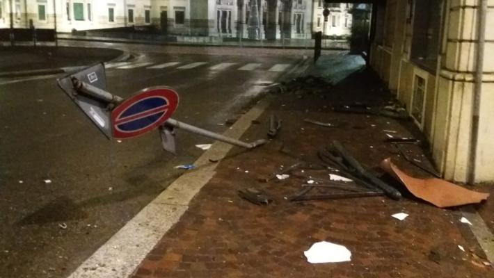 Corsa pazza in auto in pieno centro: sbanda, abbatte un cartello, centra un negozio e fugge. Ma perde la targa